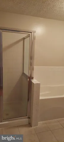 a bathroom with a glass shower door