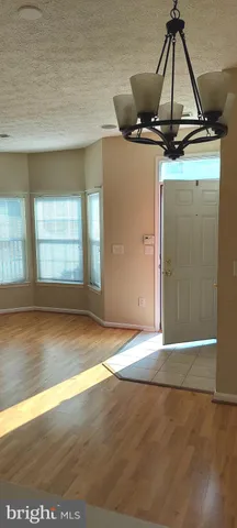 a view of a room with wooden floor and window