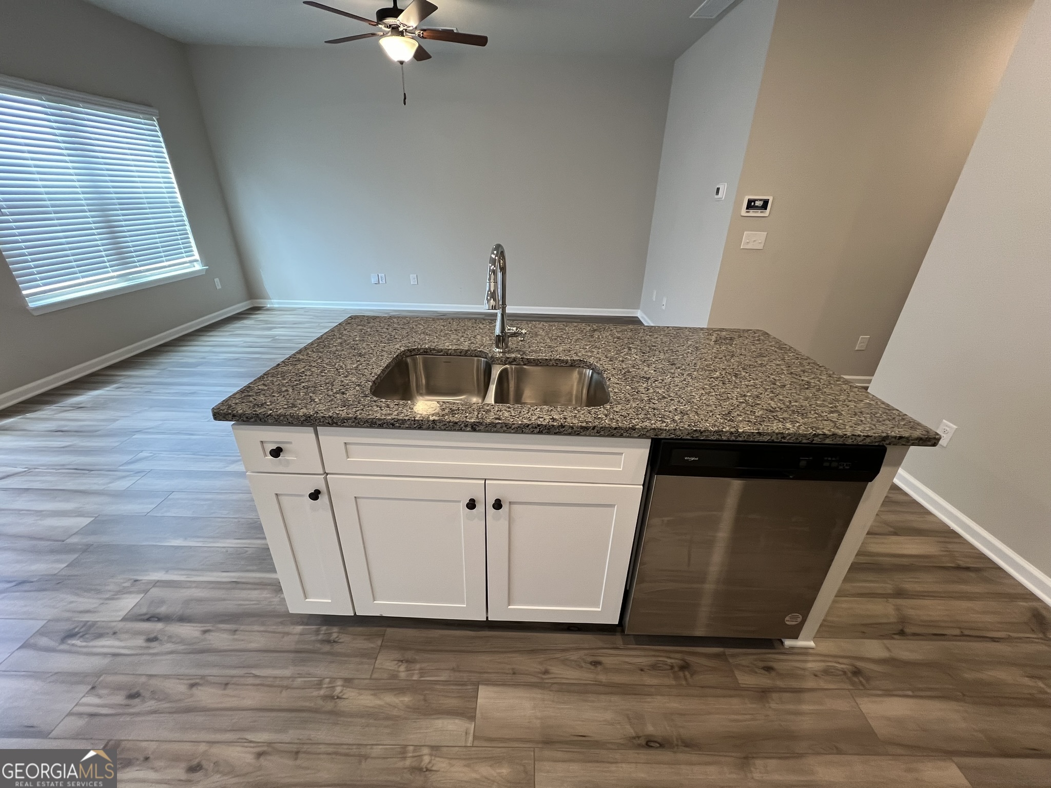 130 Skipjack Court Covington, GA 30016 - Photo 12 of 36 a kitchen with a sink window and cabinets