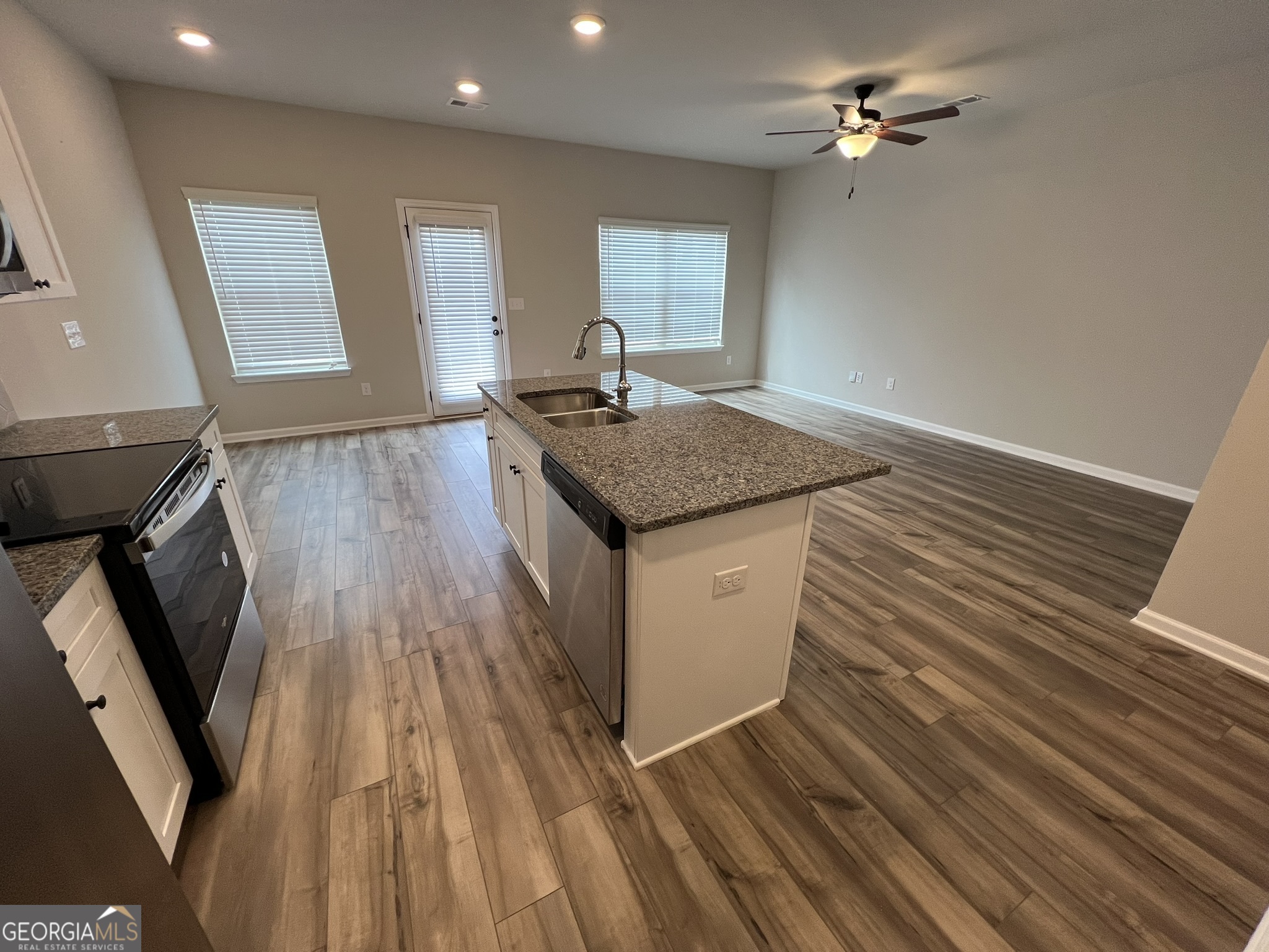 130 Skipjack Court Covington, GA 30016 - Photo 13 of 36 a kitchen with a sink and wooden floor