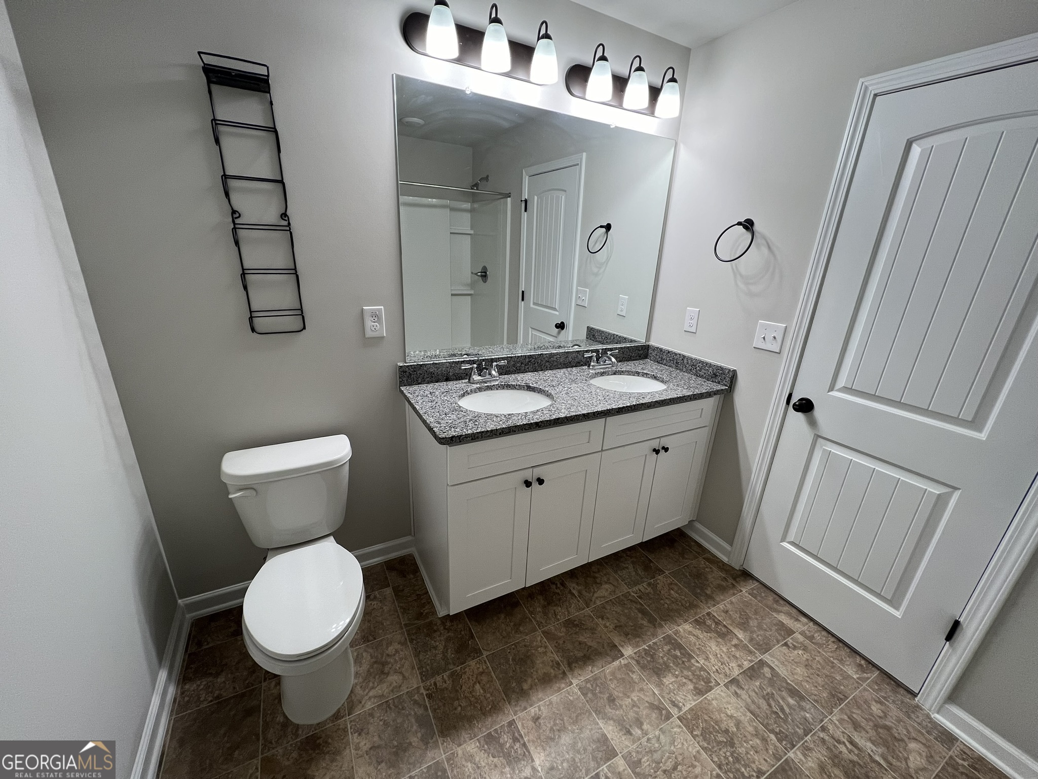 130 Skipjack Court Covington, GA 30016 - Photo 23 of 36 a bathroom with a toilet sink and mirror