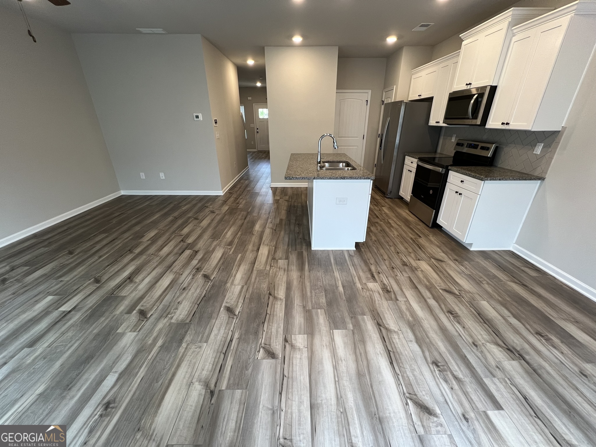 130 Skipjack Court Covington, GA 30016 - Photo 6 of 36 a view of kitchen with sink microwave and refrigerator