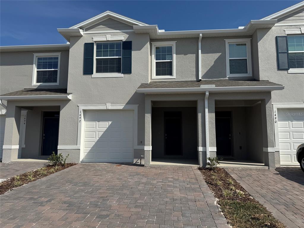 1492 Isleta Loop Kissimmee, FL 34741 - Photo 1 of 1 a front view of a house with a yard