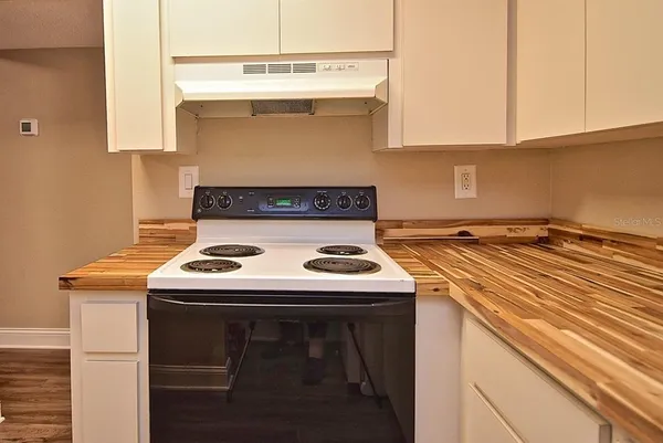 a kitchen with a stove and a microwave