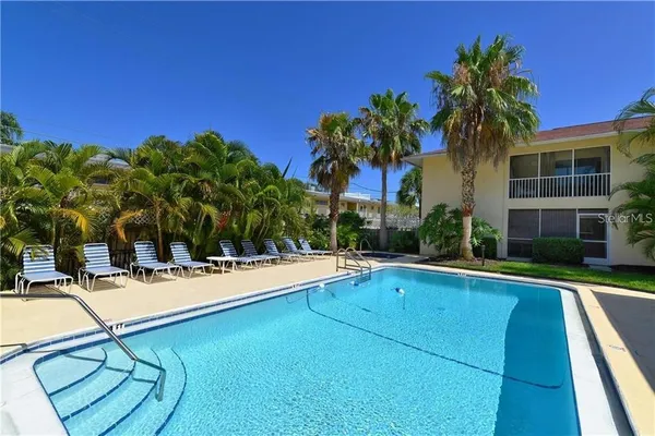 a view of house with swimming pool and porch with furniture