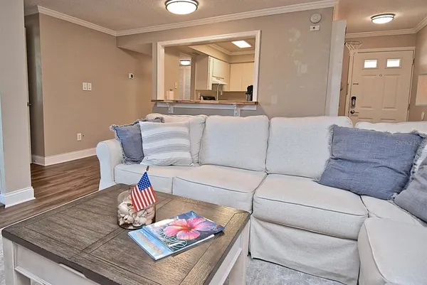 a living room with furniture and a wooden floor