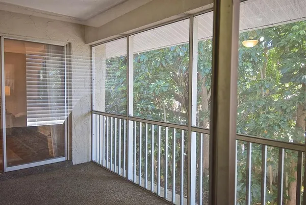 a view of a room with wooden floor and windows