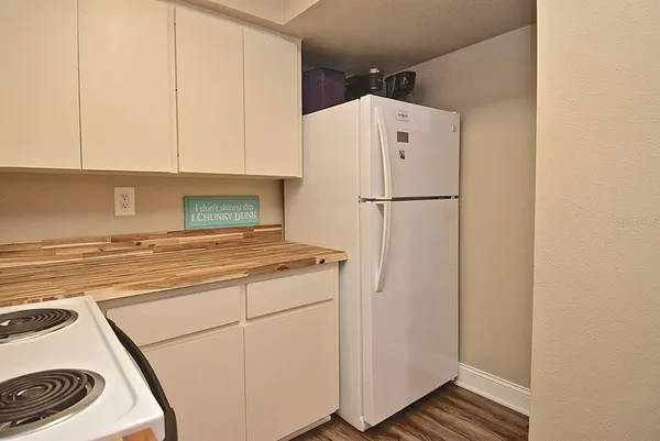 a white refrigerator freezer sitting inside of a kitchen