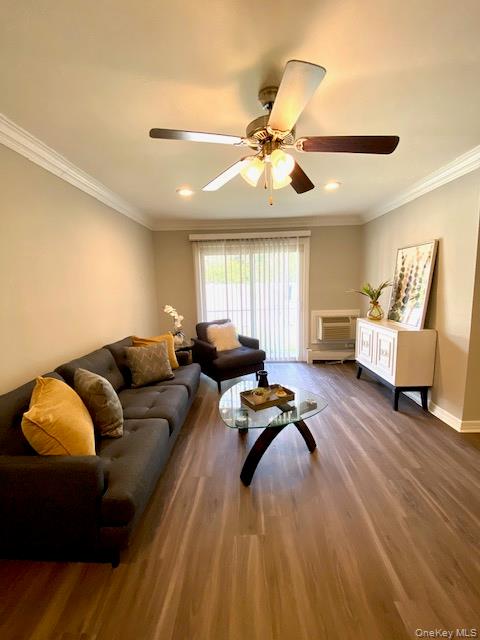 250 River Avenue, Unit 142 Patchogue, NY 11772 - Photo 4 of 9 a living room with furniture ceiling fan and a rug