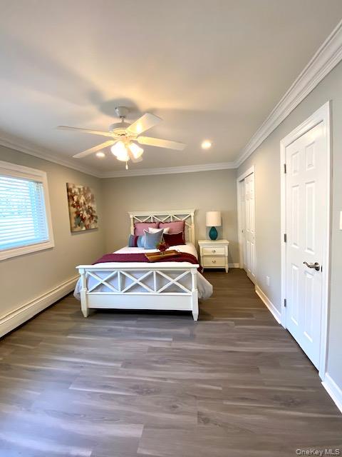 250 River Avenue, Unit 142 Patchogue, NY 11772 - Photo 8 of 9 a bedroom with a bed and wooden floor