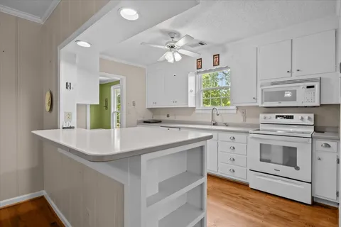 a kitchen with cabinets a sink and appliances
