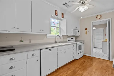 a kitchen with cabinets appliances and a window