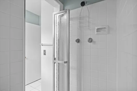 a bathroom with a glass shower door