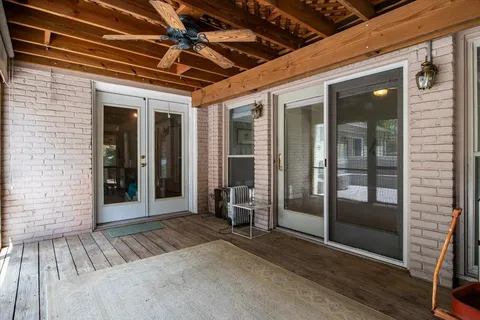 a view of a hallway with wooden floor and door
