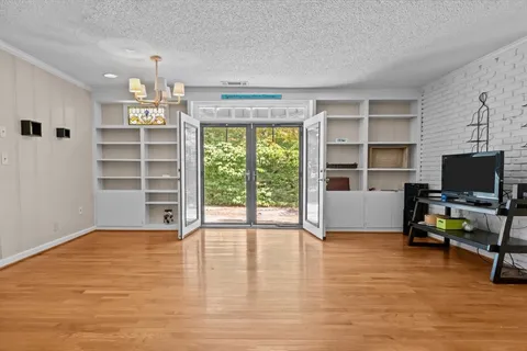 a view of a livingroom with furniture and a flat screen tv