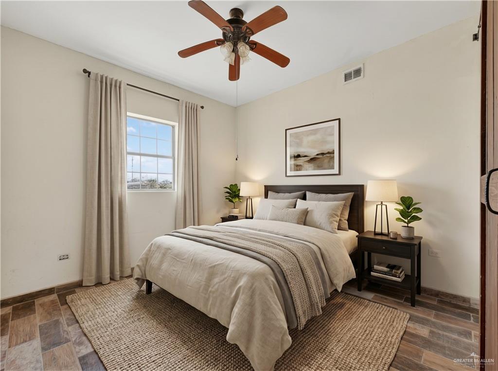 1424 North Sky Soldier Road Weslaco, TX 78596 - Photo 17 of 33 a bedroom with a bed and a painting