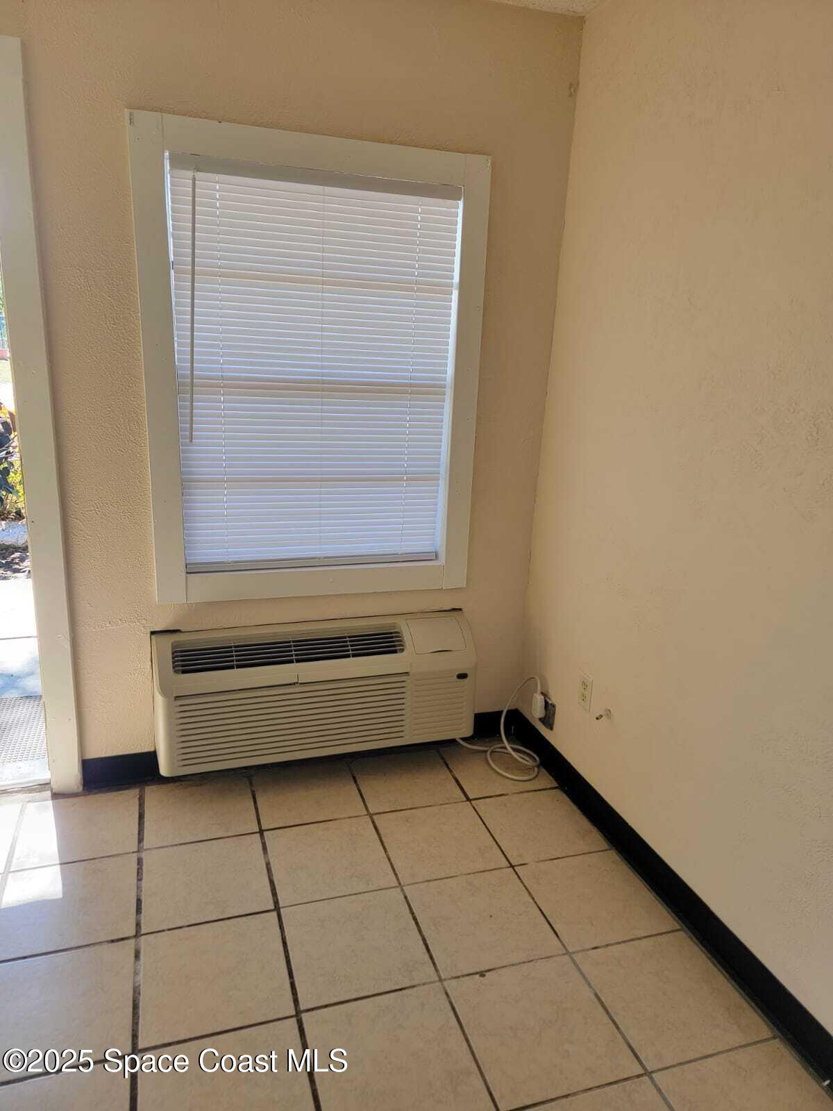 2205 Knox McRae Drive Titusville, FL 32780 - Photo 5 of 9 a view of an empty room with a window