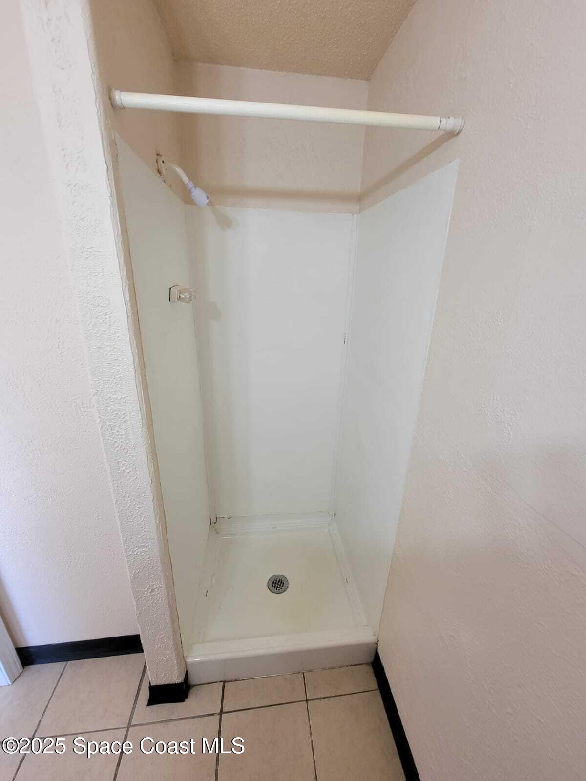 2205 Knox McRae Drive Titusville, FL 32780 - Photo 7 of 9 a bathroom with a glass shower door