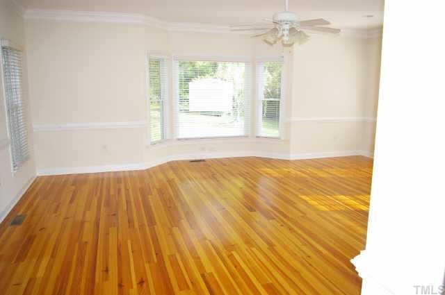 3412 Malibu Drive Raleigh, NC 27607 - Photo 4 of 6 a view of a room with wooden floor and windows