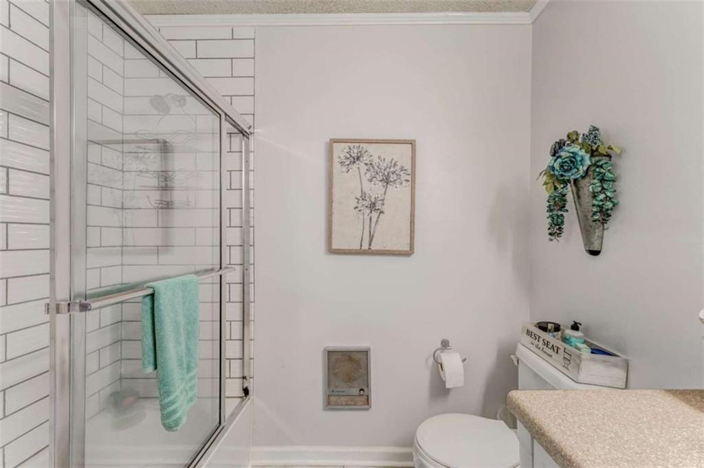 8690 Silver Hill Road Lyerly, GA 30730 - Photo 24 of 35 a bathroom with a toilet sink and shower