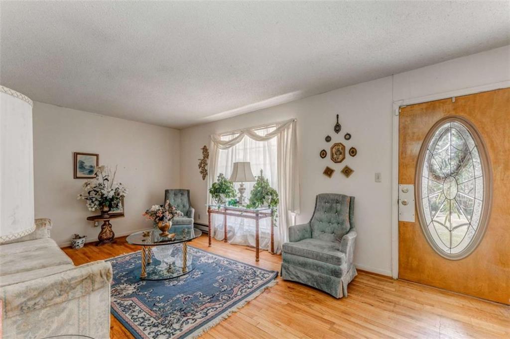 8690 Silver Hill Road Lyerly, GA 30730 - Photo 7 of 35 a living room with furniture a rug a wall clock and a potted plant