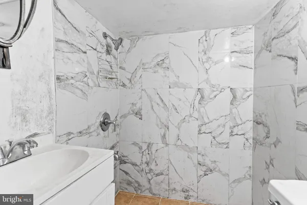 a bathroom with shower sink and toilet