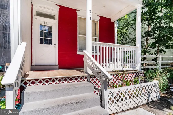 a view of a bench in front of house