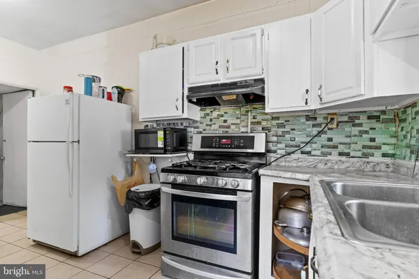 a kitchen with stainless steel appliances granite countertop a stove a refrigerator and a sink