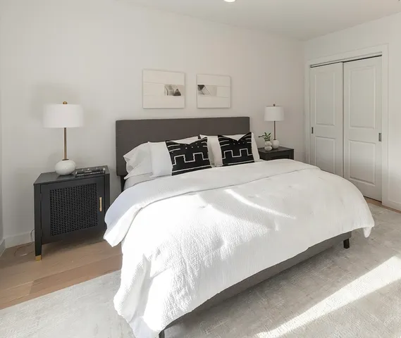 a bedroom with a bed and a night stand