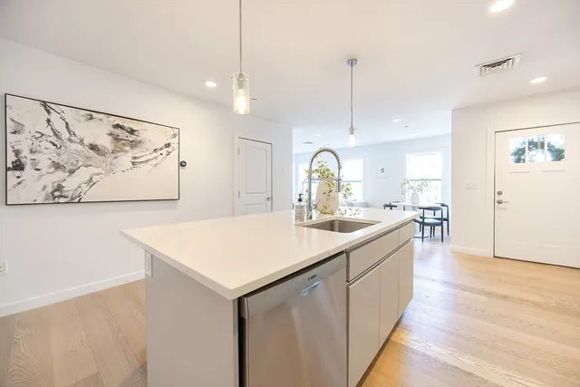 a view of kitchen with sink and wooden floor
