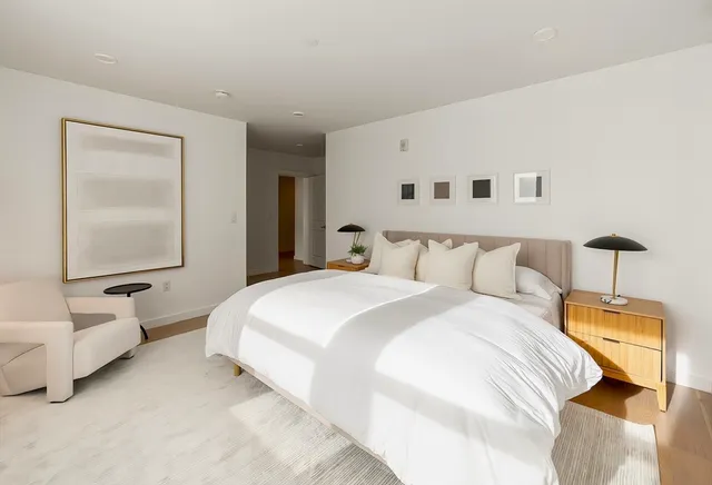 a bedroom with a bed and a large mirror