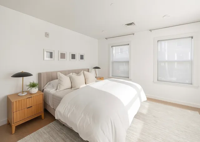 a spacious bedroom with a bed and a window