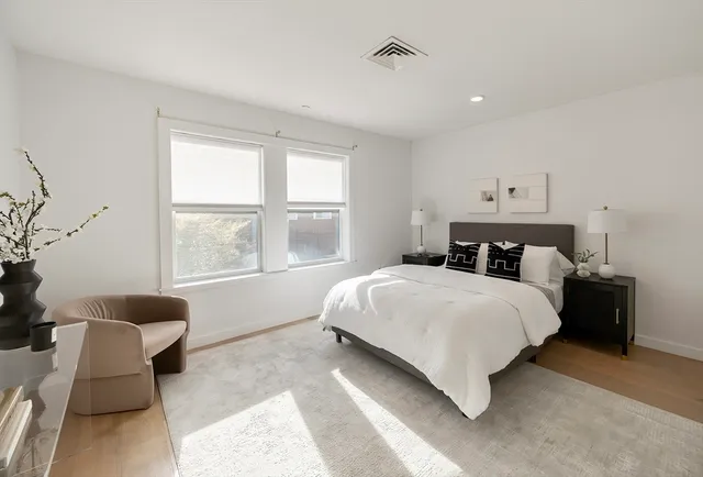 a bedroom with a bed and a couch