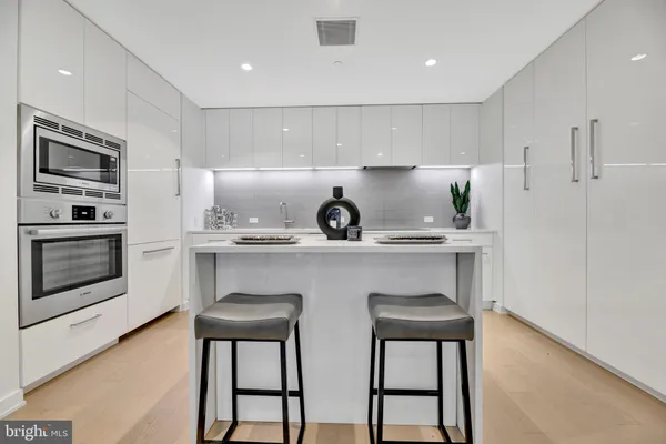 a kitchen with stainless steel appliances a sink stove and microwave