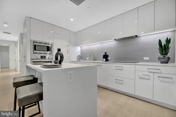 a kitchen with appliances a sink and cabinets