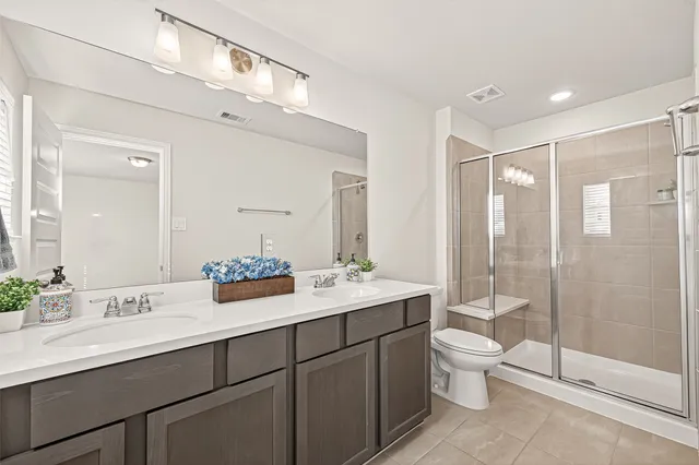 a bathroom with a shower a toilet and sink