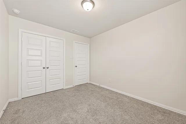 an empty room with closet area