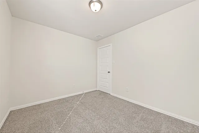 a view of a backyard with wooden fence