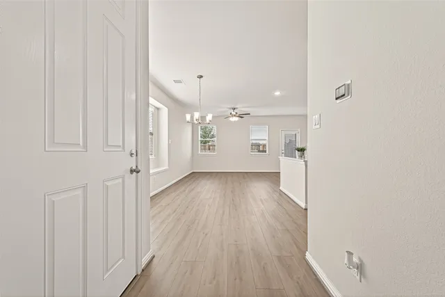 a view of a room with wooden floor and a window