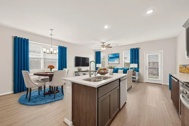 a room with a table chairs and a wooden floor