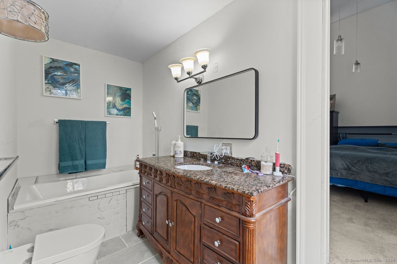 8 Tom Road East Haddam, CT 06423 - Photo 15 of 26 a bathroom with a granite countertop toilet sink and mirror
