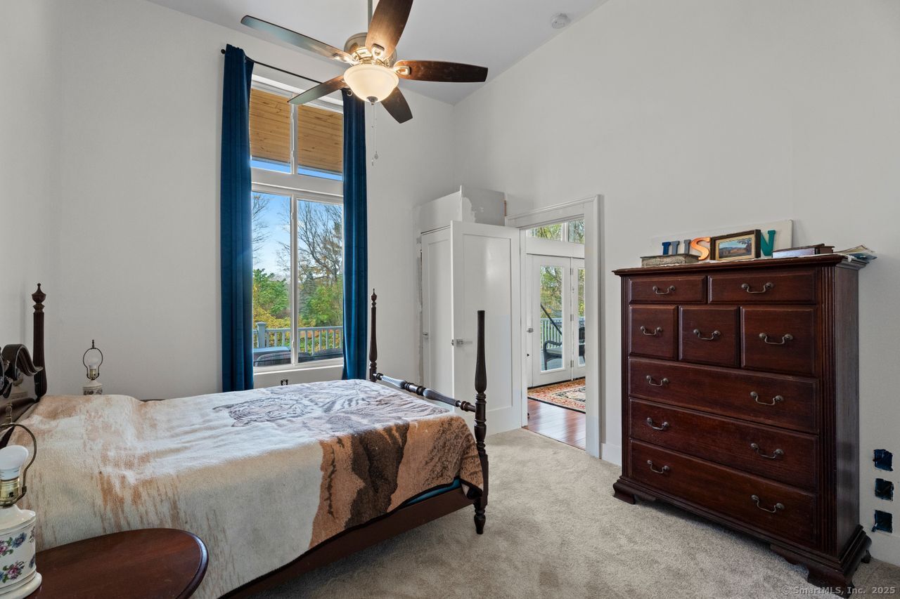 8 Tom Road East Haddam, CT 06423 - Photo 16 of 26 a bedroom with a bed and a chandelier