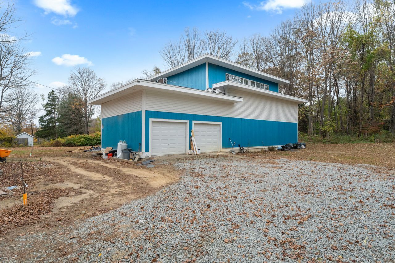 8 Tom Road East Haddam, CT 06423 - Photo 6 of 26 a view of a house with a yard and garage