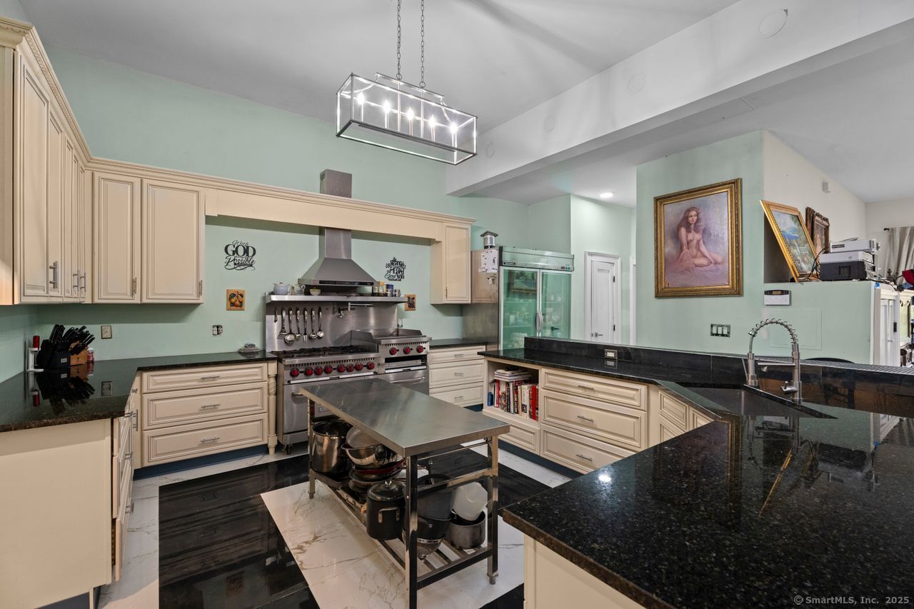 8 Tom Road East Haddam, CT 06423 - Photo 8 of 26 a kitchen with a table chairs stove and cabinets