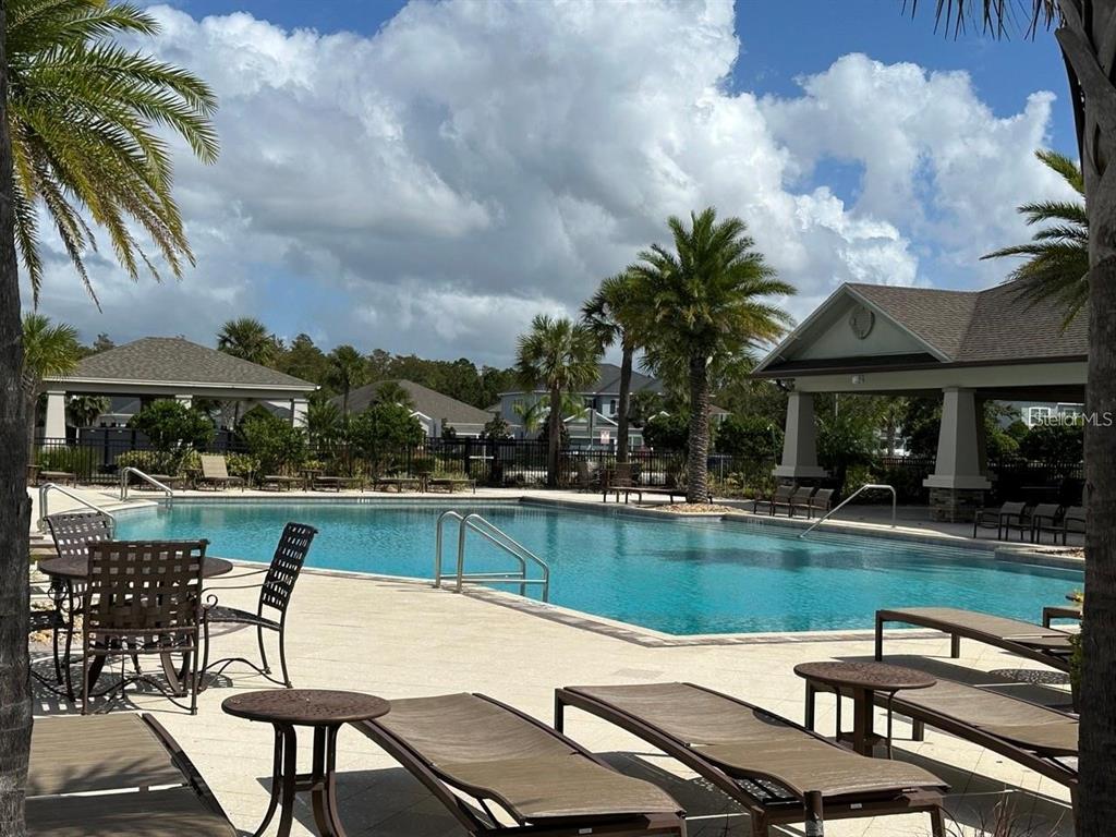 12254 Sandy Apple Road Orlando, FL 32824 - Photo 14 of 14 a view of a swimming pool with chairs