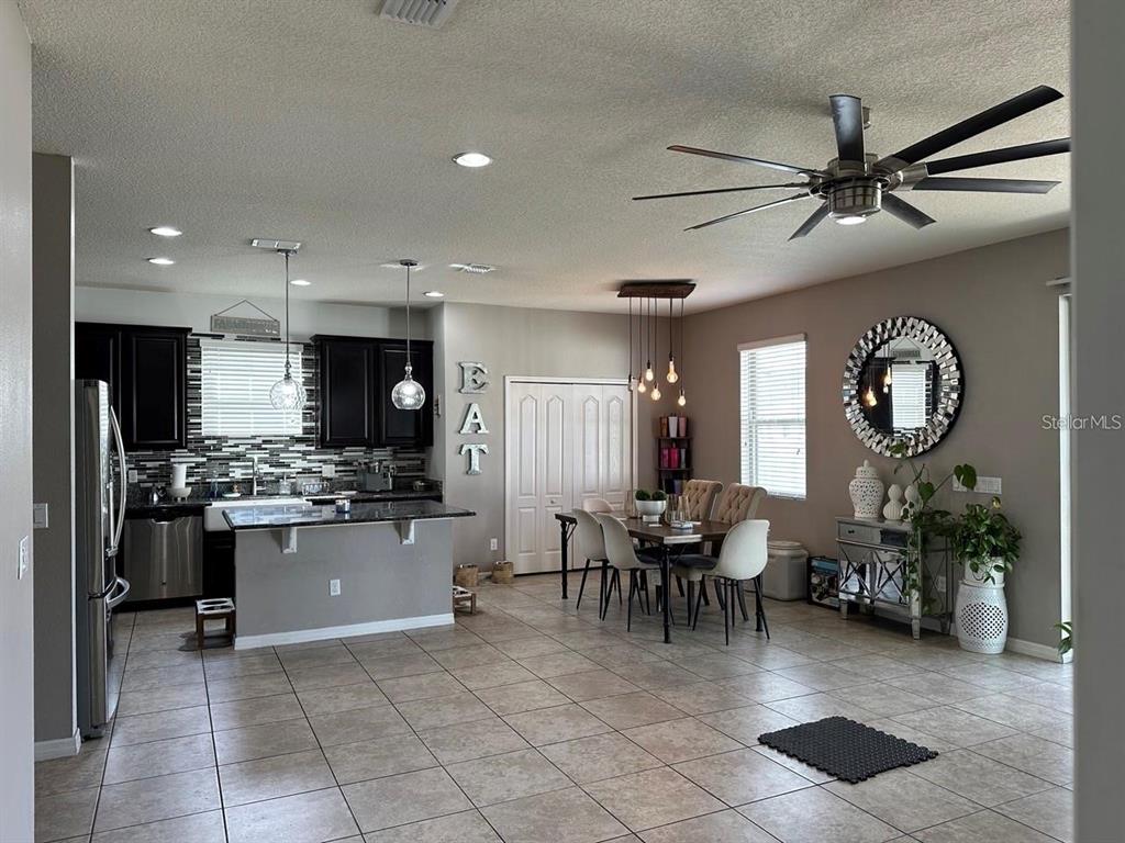 12254 Sandy Apple Road Orlando, FL 32824 - Photo 3 of 14 a view of a kitchen and dining room