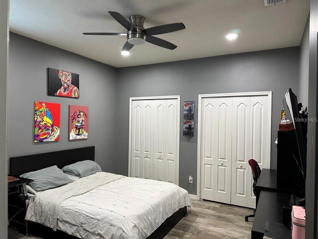 12254 Sandy Apple Road Orlando, FL 32824 - Photo 6 of 14 a bedroom with a bed and a painting on the wall