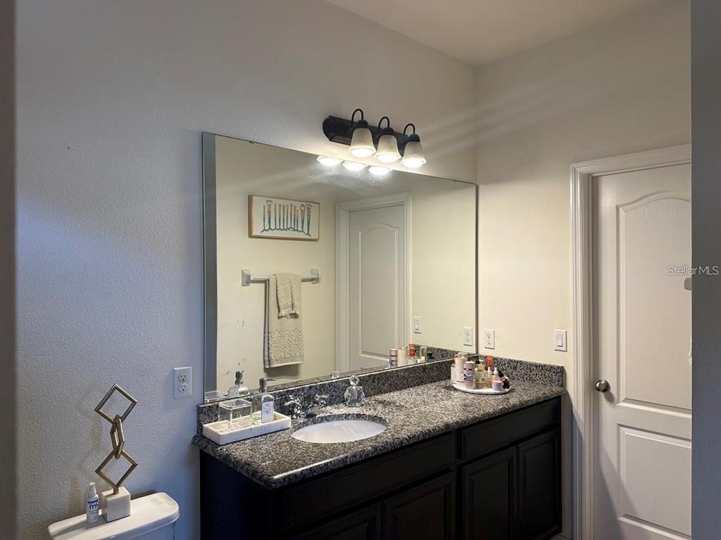 12254 Sandy Apple Road Orlando, FL 32824 - Photo 8 of 14 a bathroom with a sink and a mirror