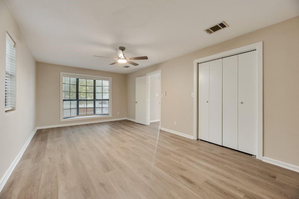 5706 Rocky Ridge Road Dallas, TX 75241 - Photo 12 of 31 a view of an empty room with wooden floor and a window