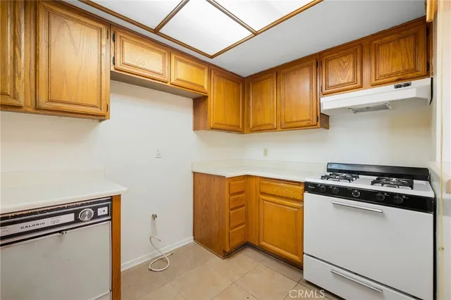 a kitchen with stainless steel appliances granite countertop cabinets and a stove top oven